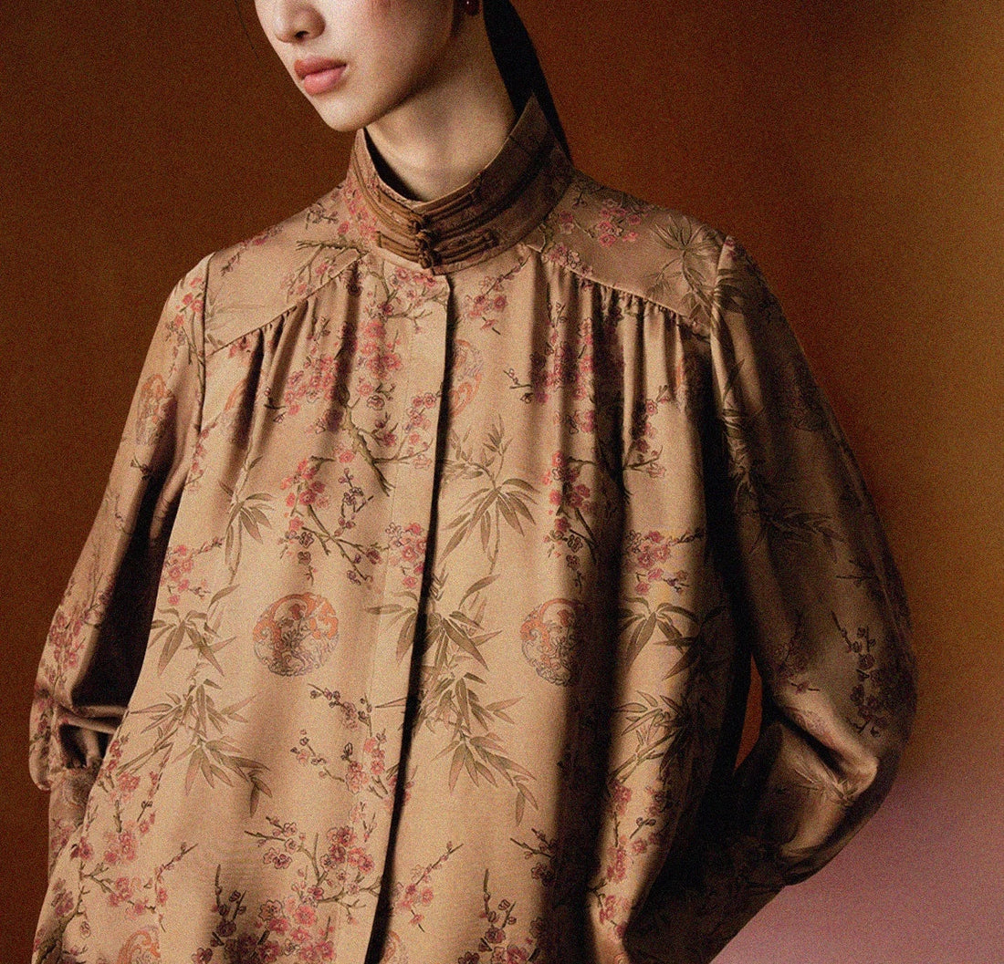 woman wearing irregular black short stand collar jacket with  silver buckles. 