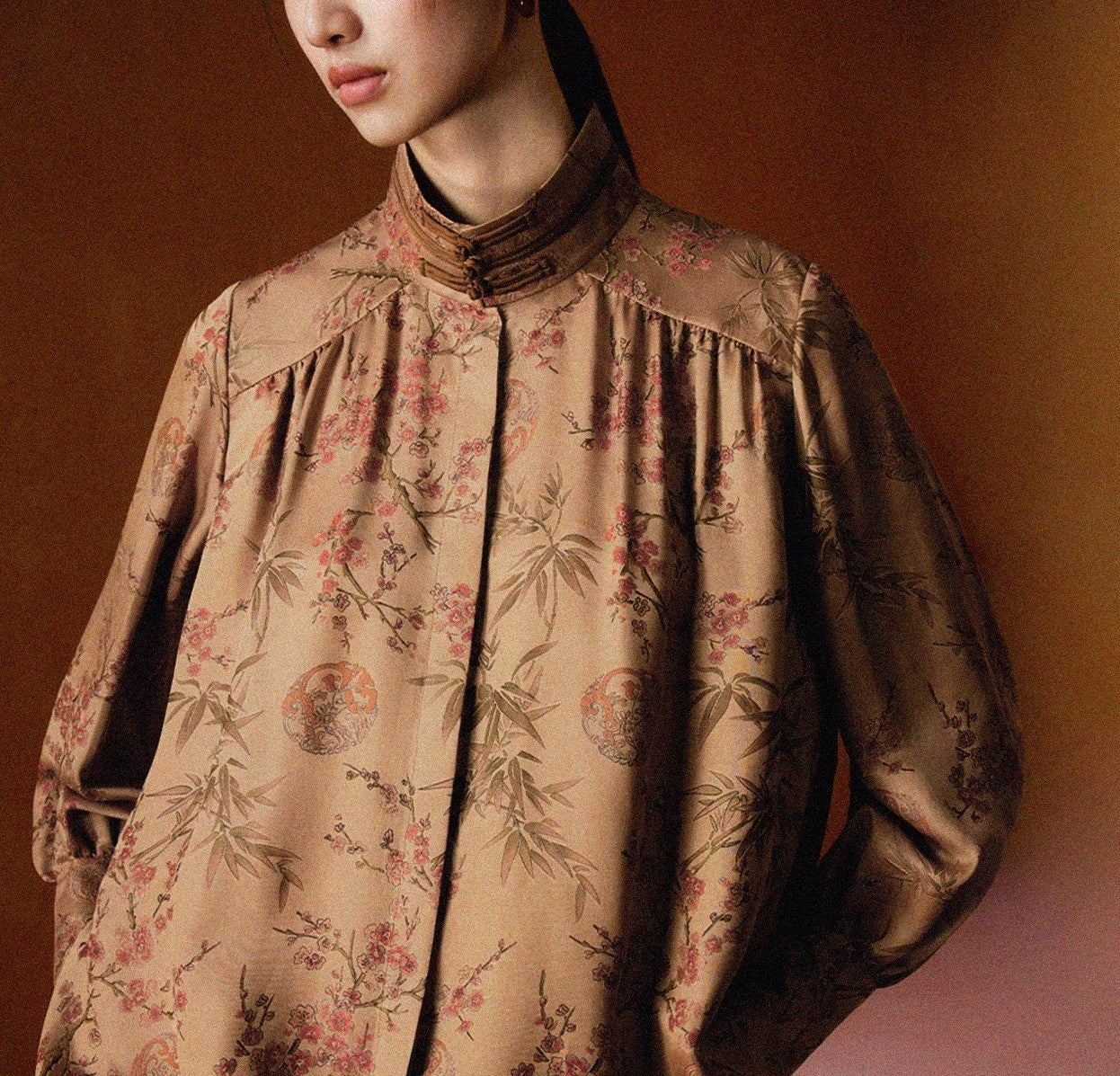 woman wearing irregular black short stand collar jacket with  silver buckles. 