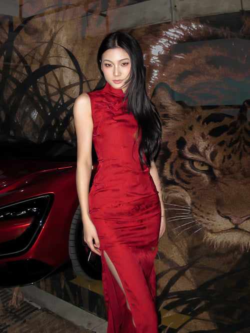 Woman in a red dress standing next to a car with a tiger mural in the background