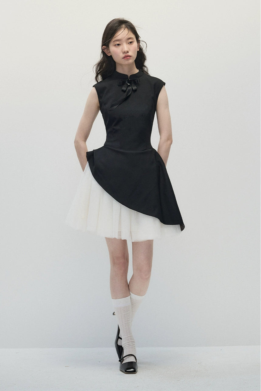 Woman wearing a black and white dress with a plain background