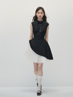 Woman wearing a black sleeveless dress with a white background