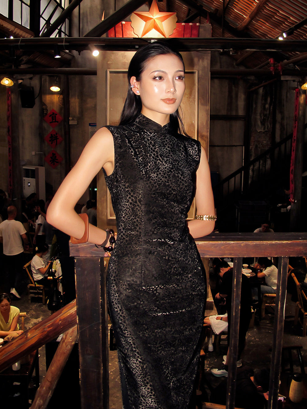 Woman in a black dress standing in a restaurant setting