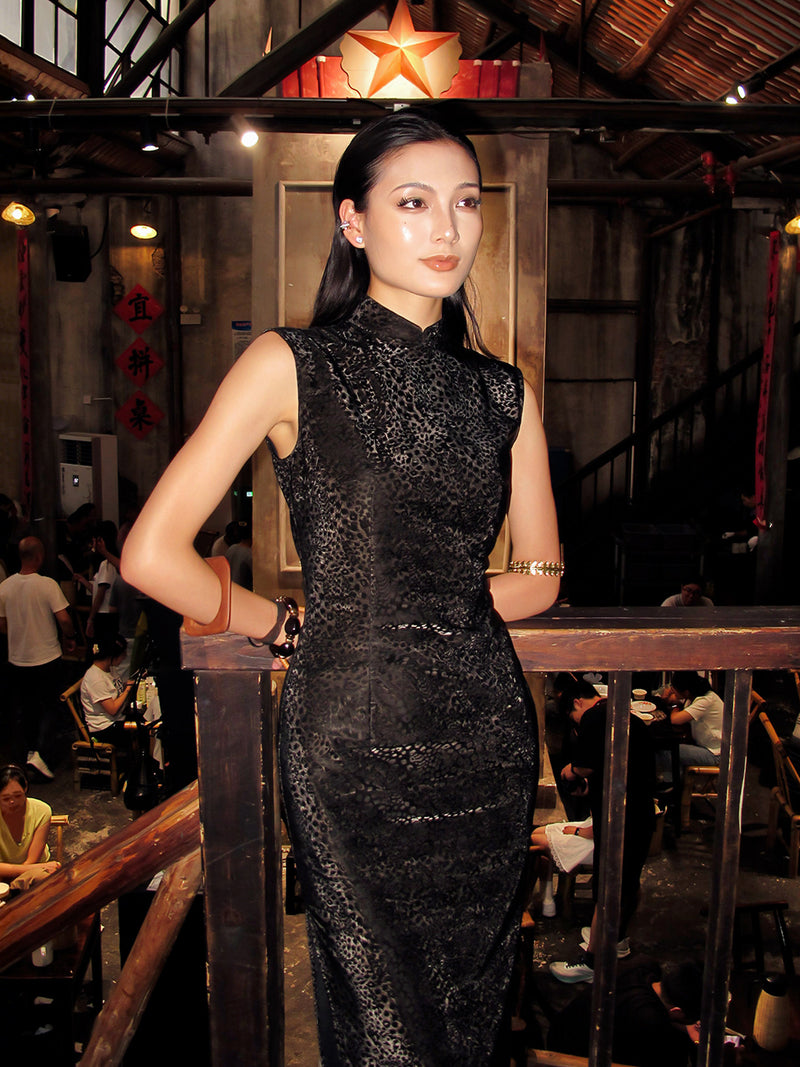 Woman in a black dress standing in a restaurant setting