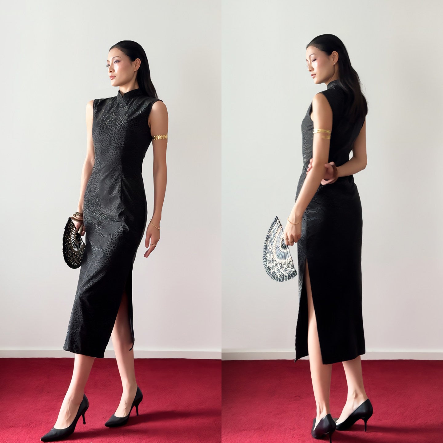 Woman in a black dress with a high slit standing on a red carpet against a white wall.