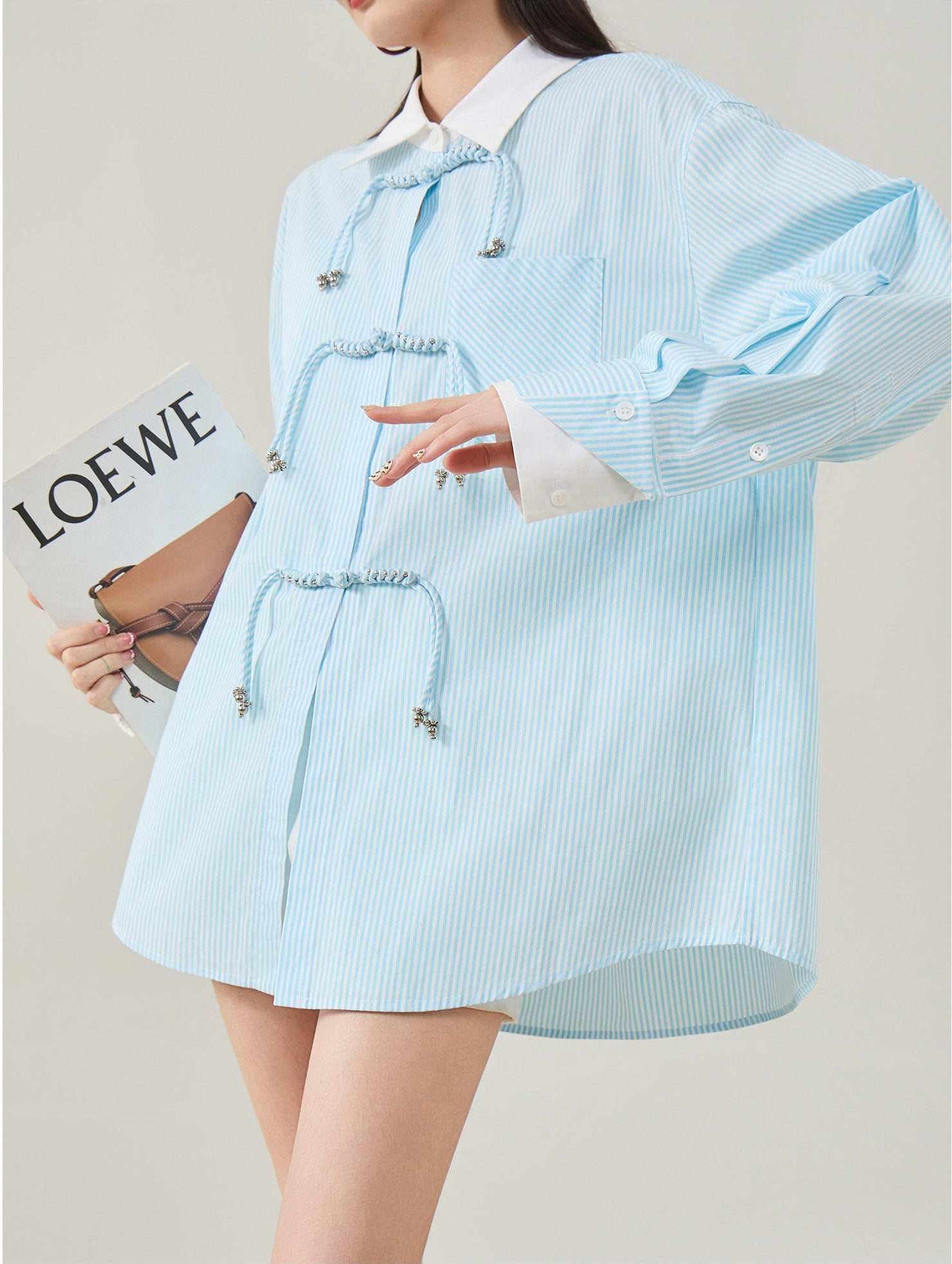 Light blue striped shirt worn by a person on a plain background