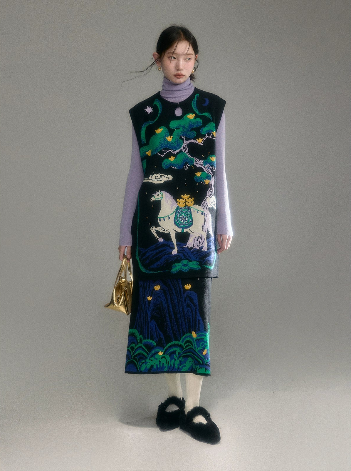 Woman wearing a patterned dress with a horse design on a plain background