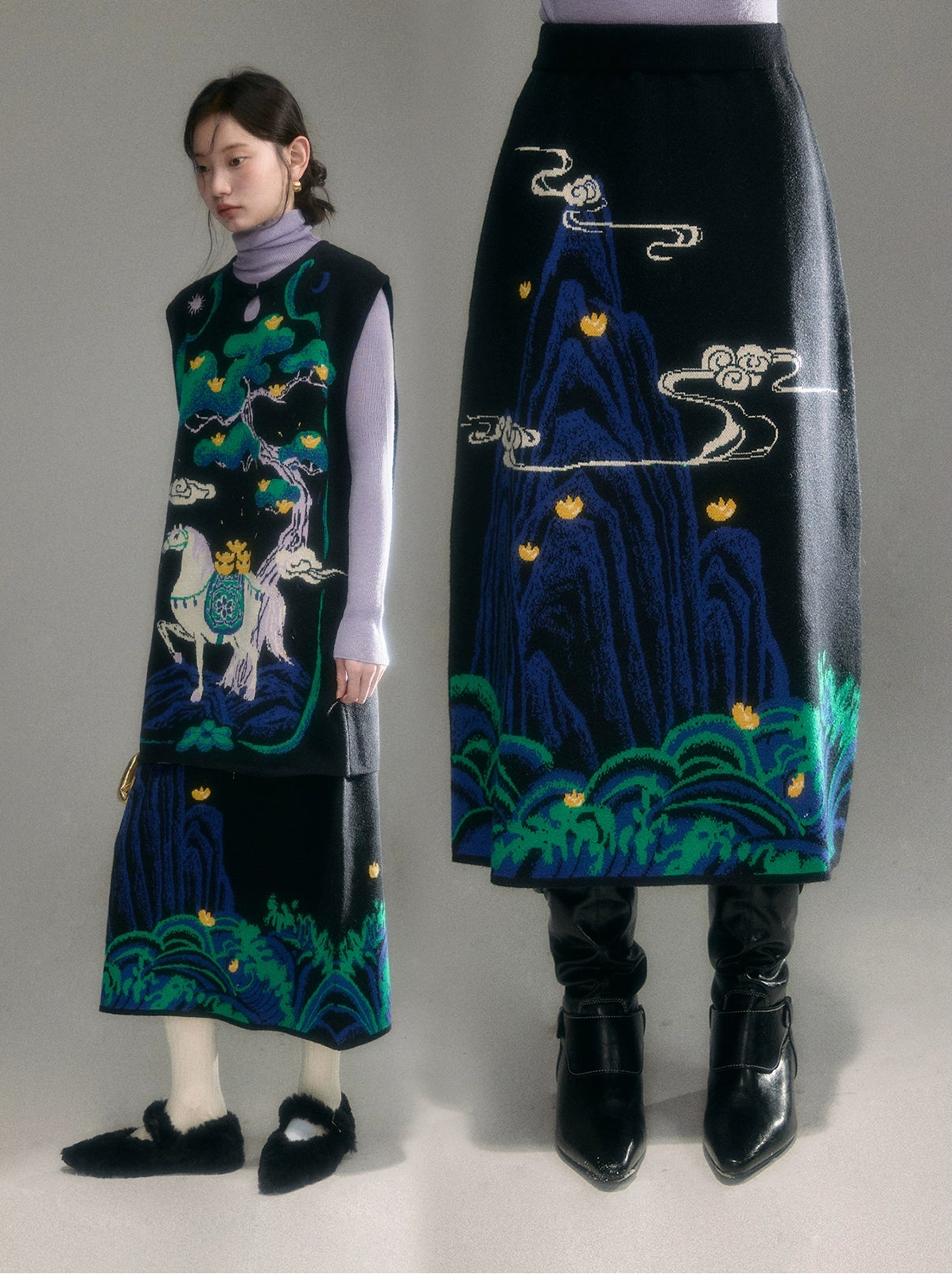 Woman wearing a black embroidered dress with a mountain design, standing next to the dress on a gray background.