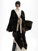 Person wearing a dark brown textured kimono with a white shirt underneath on a white background