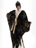 Person wearing a dark floral robe with a white background