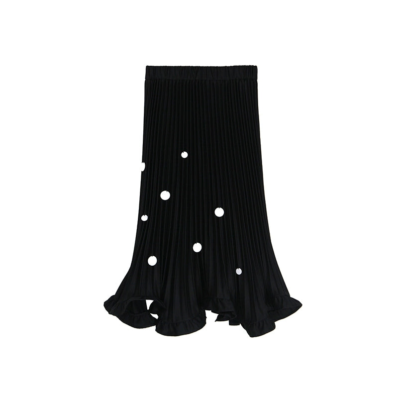 Black pleated skirt with white polka dots on a white background
