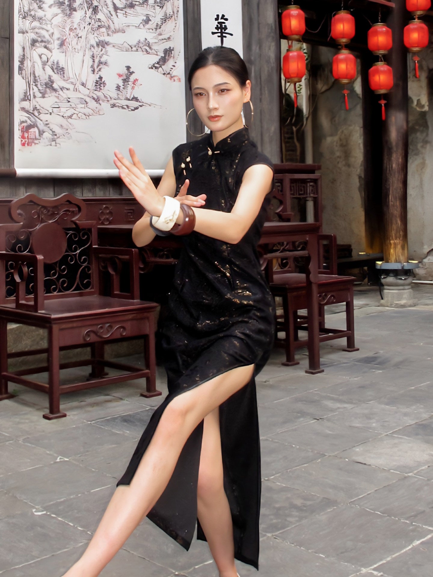 Woman in a black dress posing in an outdoor setting with traditional Chinese decor.