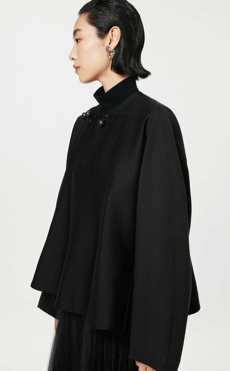 Person wearing a black coat on a white background