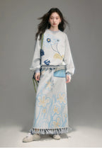 Woman wearing a floral outfit with a gray background