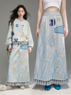 Two models wearing matching floral outfits with a gray background