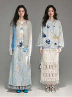 Two models wearing floral and embroidered outfits on a plain background