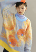Person wearing a colorful sweater with abstract design on a plain background