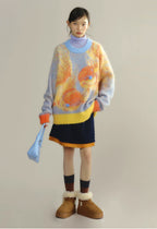 Person wearing a colorful sweater with abstract design, skirt, and boots on a plain background