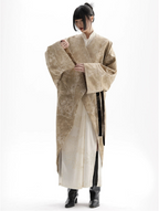 Person wearing a traditional beige and white robe with a belt on a white background