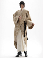 Person wearing a traditional beige and white garment on a white background