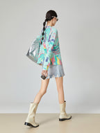 Person wearing a colorful jacket and light-colored boots on a plain background