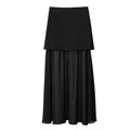 A black two-tier midi skirt with a structured, wide top layer and a flowing, gathered bottom layer, shown against a plain white background.