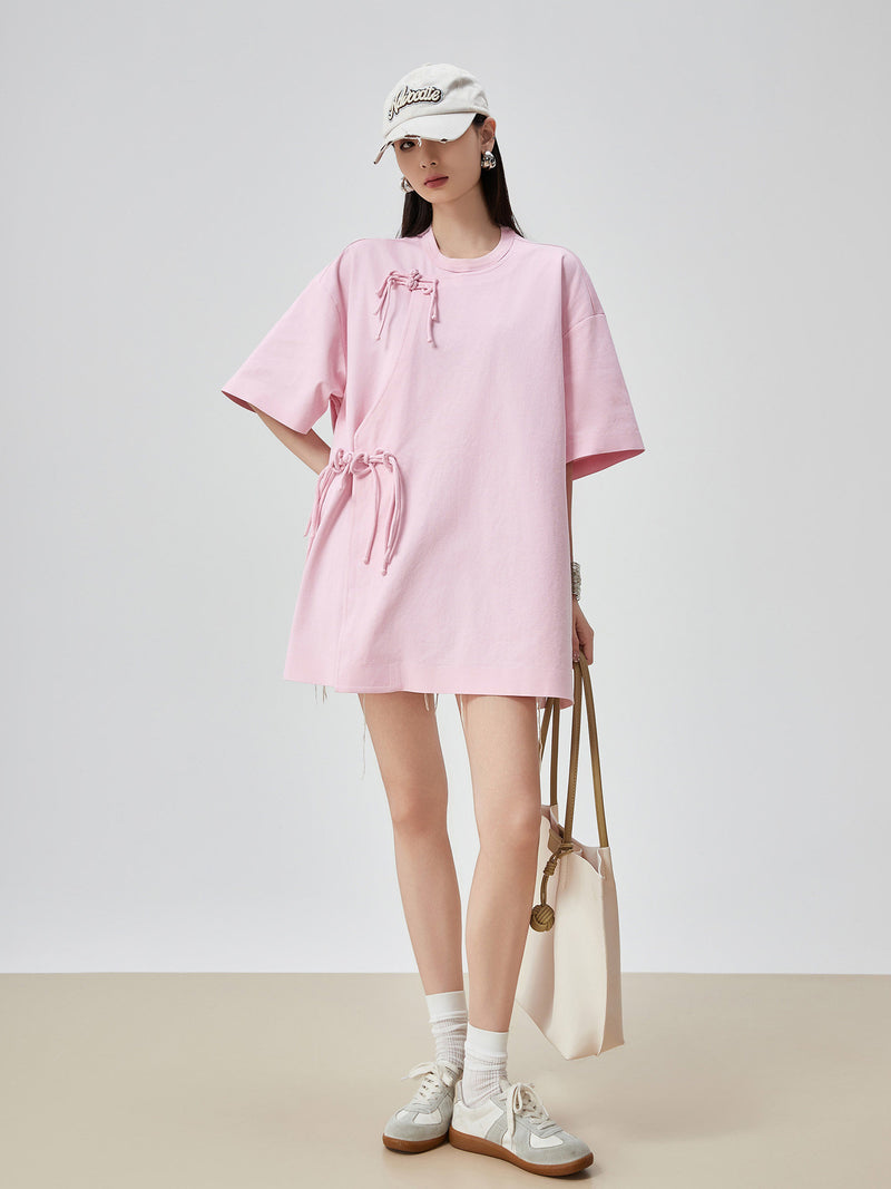 Person wearing a pink dress with a white background