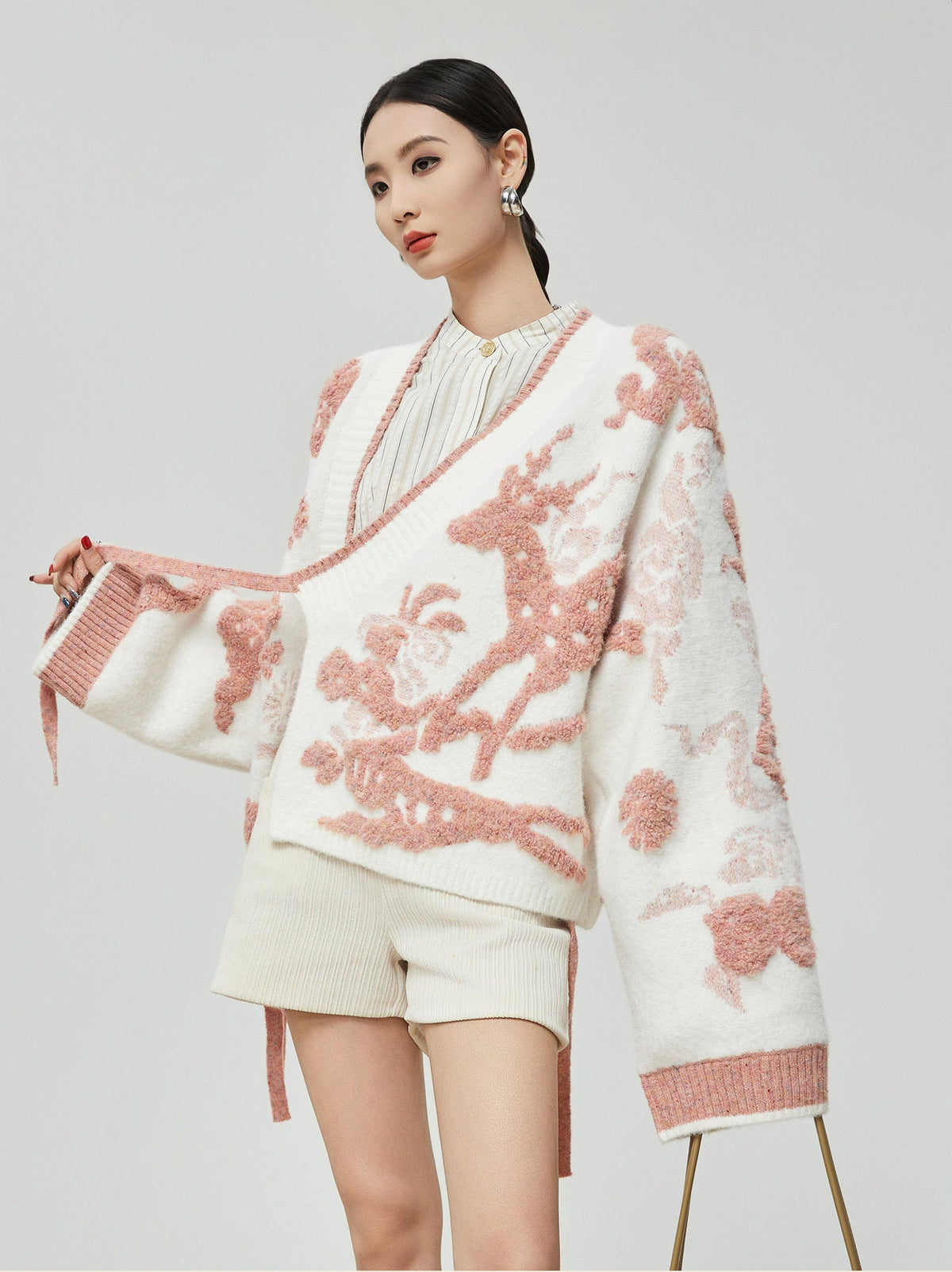 Woman wearing a floral-patterned outfit with a white background