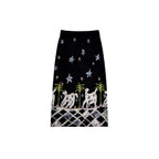 Black skirt with white animal and star pattern on a white background