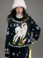 Person wearing a black sweater with a colorful design against a gray background