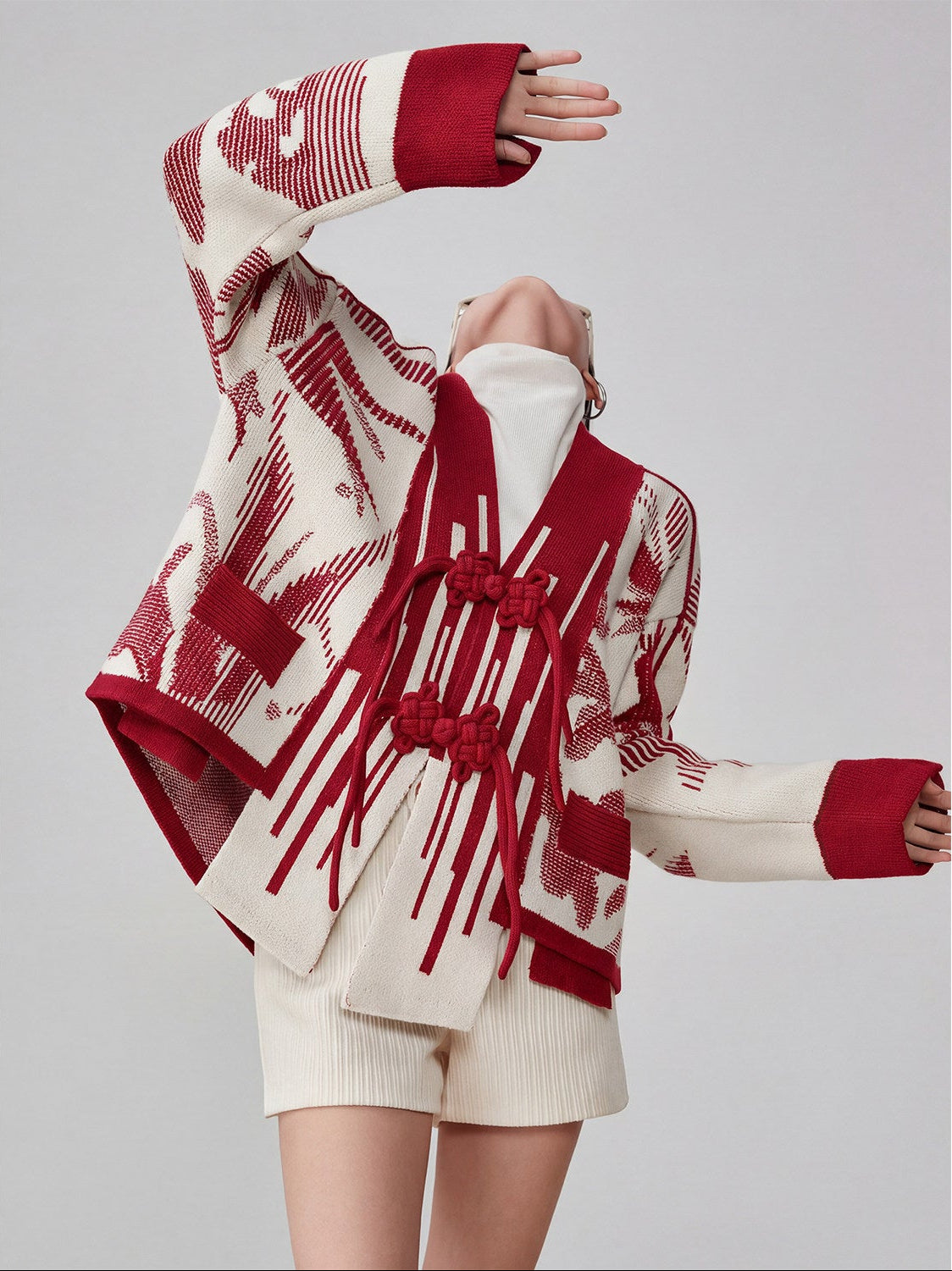 Person wearing a red and white patterned outfit on a gray background