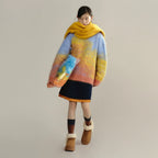 Person wearing a colorful sweater and yellow scarf on a plain background