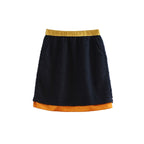 Black skirt with yellow waistband and orange hem on a white background