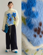 Person wearing a sweater with floral patterns and close-up of fabric texture.