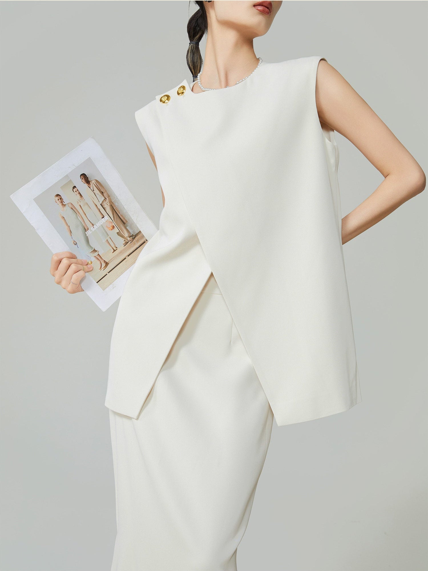 Woman wearing a white outfit with a gray background